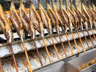 Grilled fish on sticks at street market in Munich. Traditional gastronomy from Bavaria region in Germany
