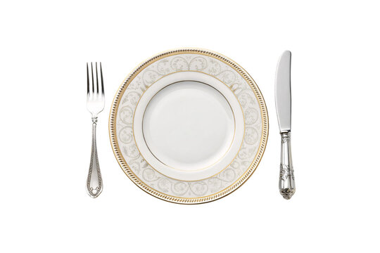 A porcelain set featuring a subtle floral motif in gold, bordered by embossed rims, paired with detailed silver flatware for timeless appeal, isolated on a transparent background