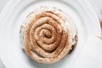 Overhead view of frosting coated cinnamon cookies, top view of cinnamon cookies with a vanilla cream frosting, process of making bakery style cookies