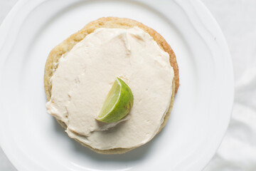 Overhead view of frosted lime and vanilla cookies, top view of bakery style lime cookies 