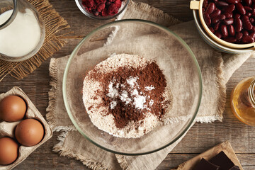Ingredients for baking gluten-free brownies - red kidney beans, oat flakes, eggs, chocolate and honey
