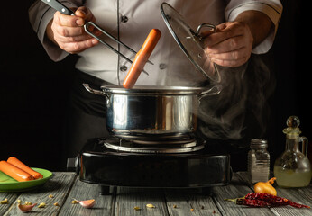 A skilled chef cooks sausages in a pot on a stovetop, lifting the lid with one hand while placing sausages inside. The kitchen atmosphere is warm and inviting, filled with steam