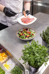 Chef adding smoked salmon