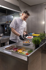 Young chef preparing a healthy salad