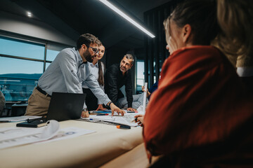 Business professionals engaged in a collaborative meeting, sharing ideas and discussing project...