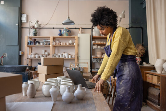 Woman using computer in Pottery Workshop Space