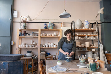 Active Potter at the Wheel Finishing a Piece