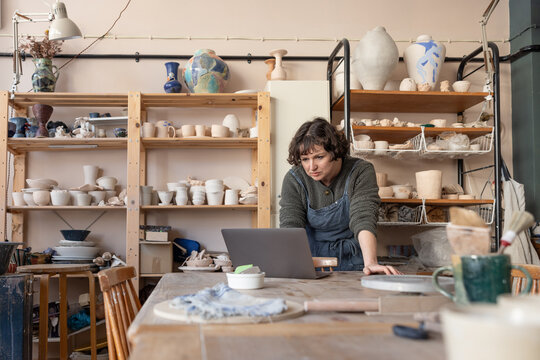 Woman starting a craft business looking at a laptop computer