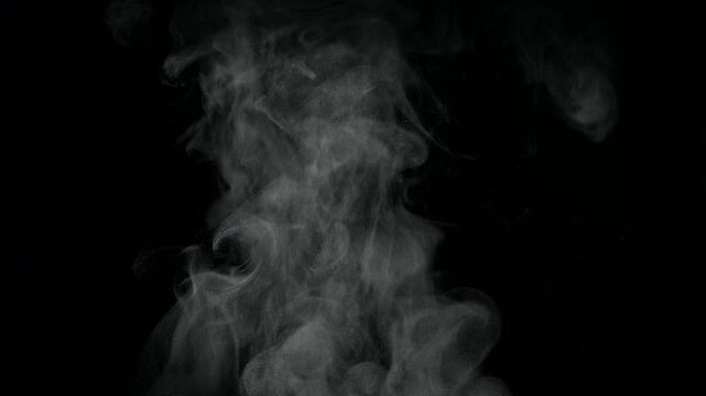 
White natural rising steam from food or hot drink isolated on a black background. Сan be used in any projects with hot food.

