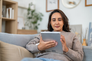 Young smiling  woman happy relax use tablet conference work,learning, education, shopping, study online webinar, online marketing, business, blog, digital internet advertising at home