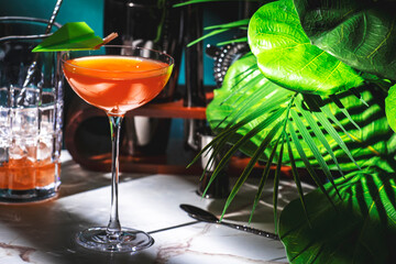 Paper plane alcoholic cocktail drink with bourbon, orange bitters, amaro and lemon juice. Marble...