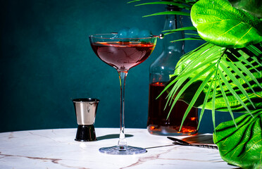 Rob Roy alcoholic cocktail drink with scotch whiskey, sweet vermouth, bitters and cherry. Marble...