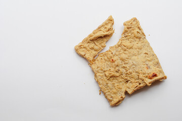 Keripik Tempe or Tempe chips, a typical Indonesian food made from thinly sliced ​​tempeh and then fried using seasoned flour. It's salty and savory. Close up and selective focus image.