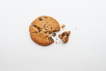 Delicious chocolate chip cookie broken into pieces on a plain white background, studio shot