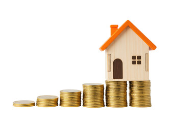 wooden miniature house with an orange roof balanced on stacks of golden coins, symbolizing real estate and financial growth, isolated on white background