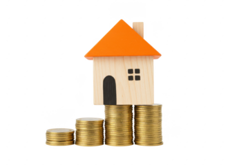 wooden miniature house with an orange roof balanced on stacks of golden coins, symbolizing real estate and financial growth, isolated on white background