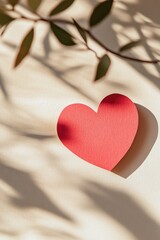 Fototapeta premium valentine's day banner red paper heart on a cream background with leaf shadows
