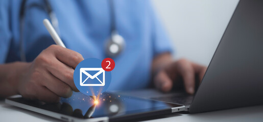 Doctor using a tablet to check new email notifications, representing digital communication in modern healthcare. technology in telemedicine, patient care and professional efficiency