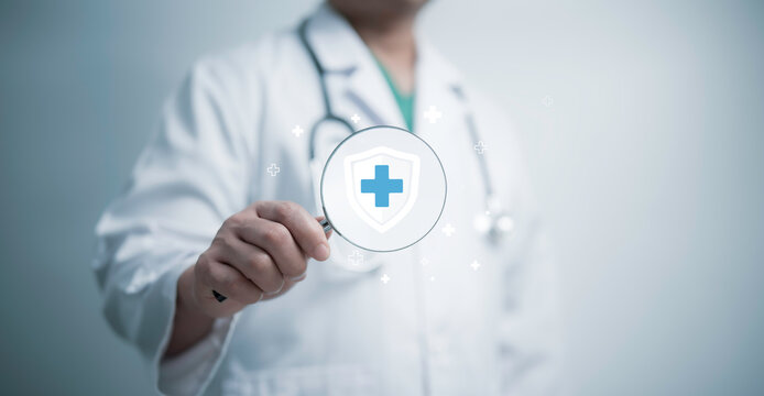 Doctor holds a magnifying glass with a medical security symbol, emphasizing research, protection, and secure healthcare services. The futuristic representation highlights advanced medical analysis