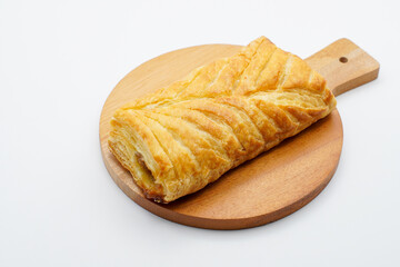 sweet bread on a wooden cutting board. freshly baked sweet bun isolated on white background.