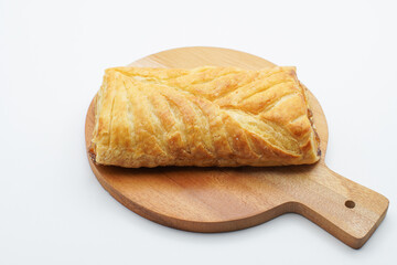 sweet bread on a wooden cutting board. freshly baked sweet bun isolated on white background.