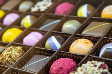 multi-colored chocolate and iced candies of different colors and shapes are neatly stacked in their places. High quality photo