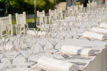 Served wedding table with plates, white chairs, napkins and wine glasses