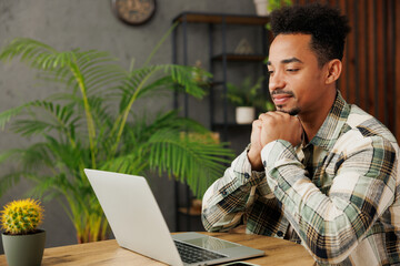 Side profile view young programmer IT man he wear grey casual clothes hold use work on laptop pc...