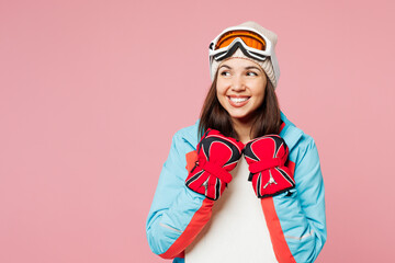 Snowboarder happy young woman wear warm blue padded jacket ski goggles mask spend extreme weekend...