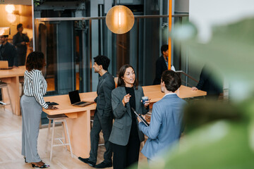 Female entrepreneur discussing with male delegate at networking event