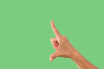 Hand gesture indicating number one against green background