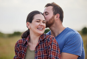 Fototapeta premium Outdoor, couple and love with kiss on farm, sustainable environment and agro field with support. Countryside, man and woman with affection embrace for admiration, agriculture and farmer in Australia