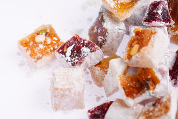 Sweet food Turkish delight, assorted rahat locum in form of cubes with nuts and powdered sugar, traditional food, on white background