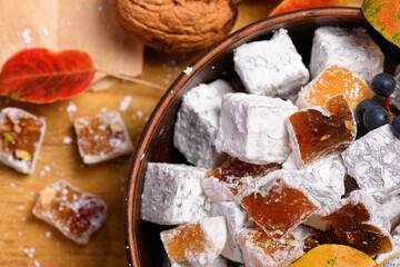 Sweet food Turkish delight on wooden background, assorted locum and candy as decorated backdrop