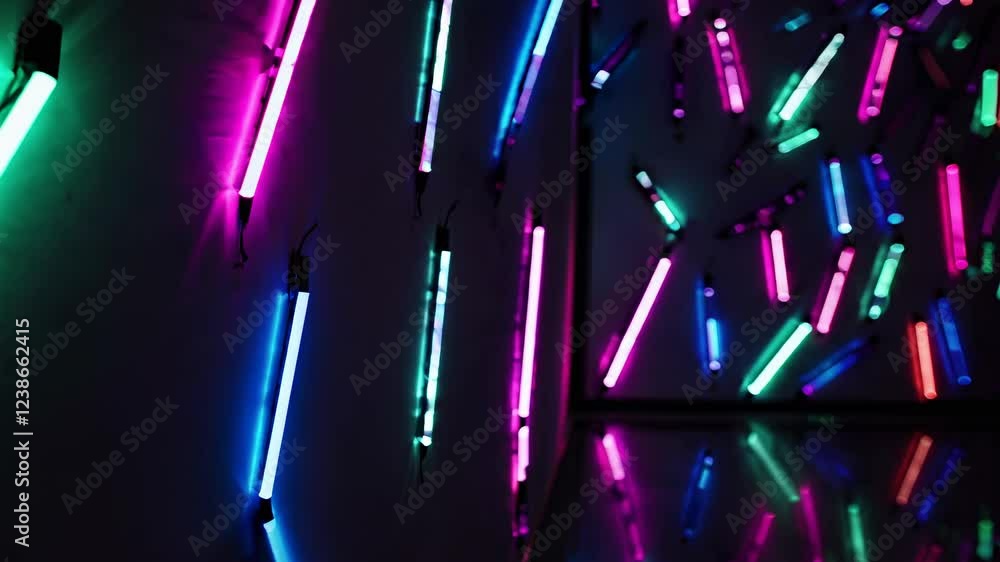 Aufkleber many colorful neon lights are attached to a dark wall and some are hanging from the ceiling, creatin