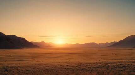 Desert sunset nature concept. A stunning sunset over vast plains with mountains in the background.