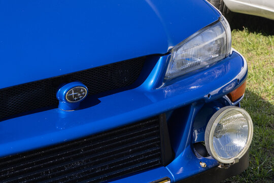 Blue subaru impreza wrx sti version v showing front grill and headlight