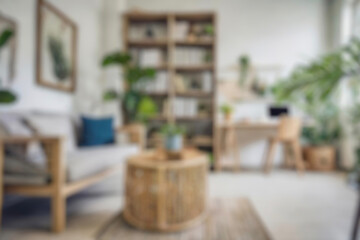Blurred view of modern living room with sofa and soft bench. room interior with couch, armchair and coffee table or shelving units. stylish living room. comfortable workplace near big window.