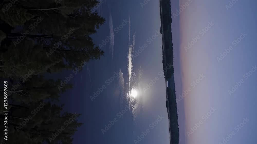 Poster moonlight reflects on still water during a serene evening by the lake in a tranquil forest setting