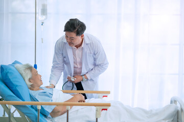 Obraz premium Doctor, medical person in hospital with stethoscope, support and healthcare professional. Asian doctor medicine and heart listening equipment, clinic and insurance for wellness help. 