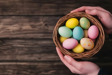 Colorful Easter eggs in a woven basket held by hands on a wooden surface create a festive spring atmosphere filled with joy and celebration