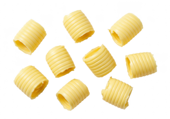 Eight rolled butter curls arranged in a scattered pattern, isolated on white background