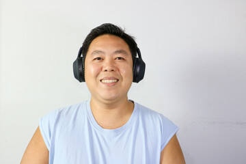 Smiling Man enjoying music with headphones