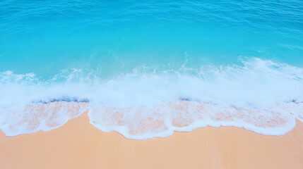 Turquoise ocean waves gently lapping a sandy beach; summer vacation background