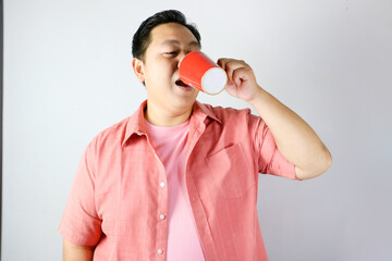 Man Enjoying a Drink from a red cup