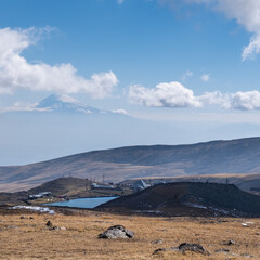Mountain village near lake Kari nearby Mount Aragats, Armenia. Mount Ararat is in the background