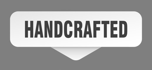 hand crafted sticker. hand crafted sign isolated on gray background