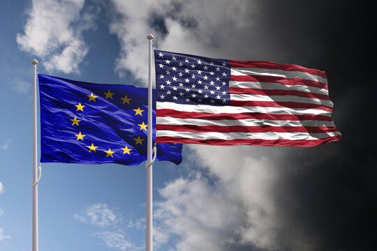 EU and USA flags above dark sky. Europe Union and United States of America trade and political confrontation - Powered by Adobe