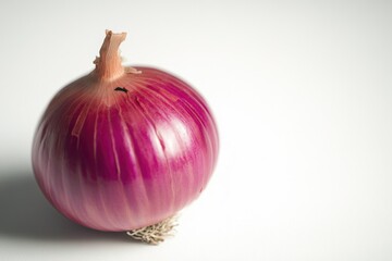 A single red onion sits atop a white table
