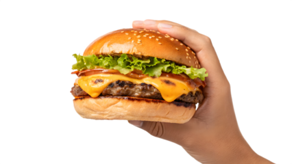 A hand holds a cheeseburger with beef, lettuce, and tomato on a burger bun